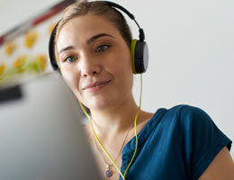 woman with headphones on laptop