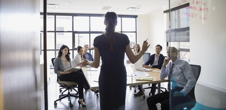 woman leading meeting in conference room